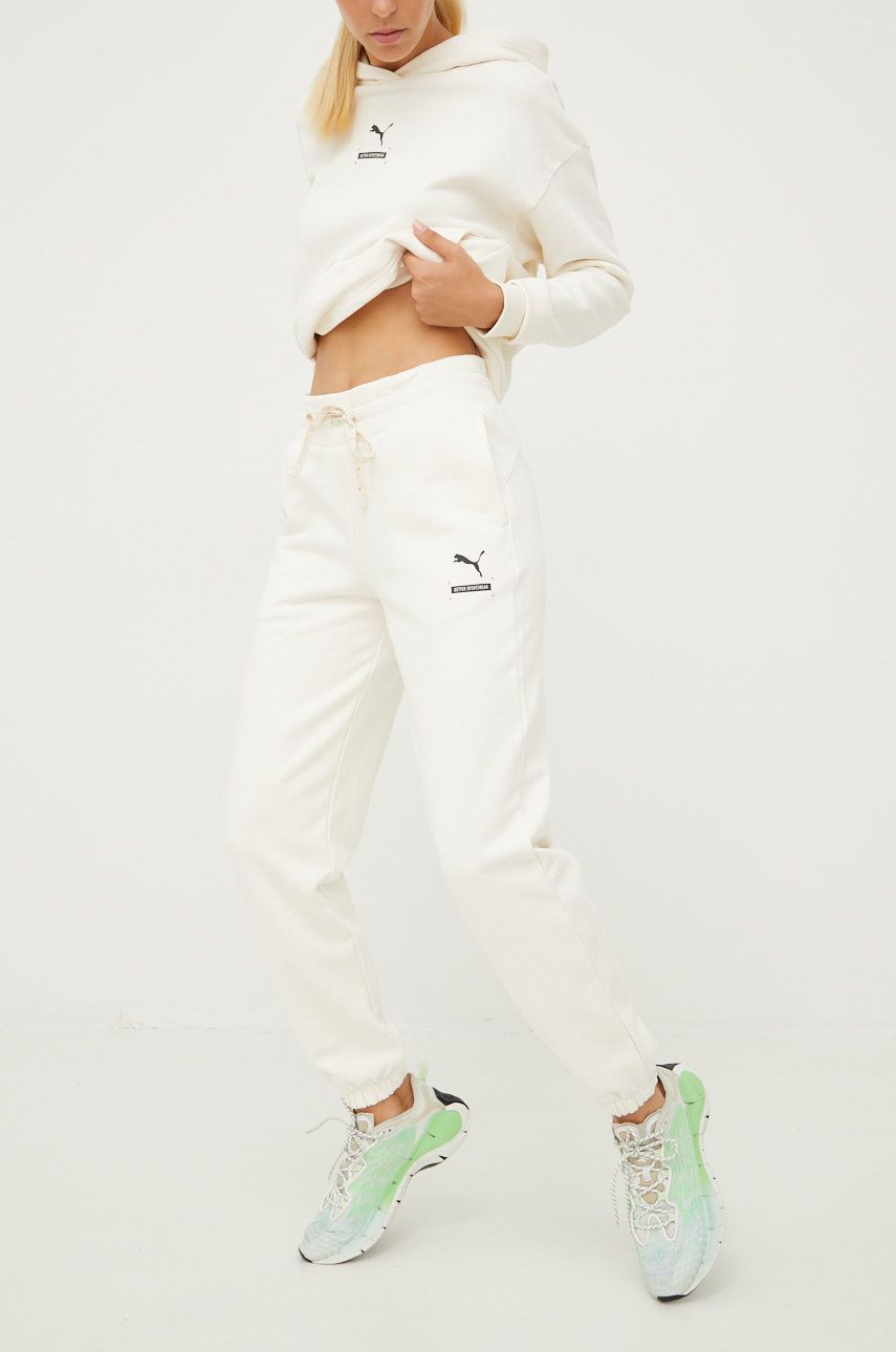 Puma spodnie dresowe bawełniane damskie kolor beżowy gładkie